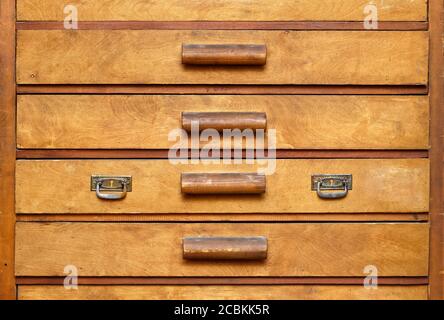 Backgrounds and textures: old wooden cabinet with drawers, front view, close-up shot Stock Photo