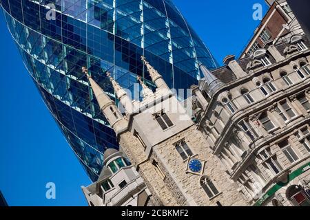 England, London, The Swiss Re building 30 St Mary Axe, alternatively known as the Gherkin, commercial skyscraper designed by architect Sir Norman Fost Stock Photo