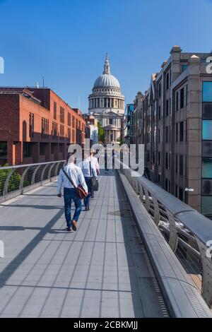 England, London, City workers crossing the Millennium Bridge towards St Paul’s Cathedral. Stock Photo