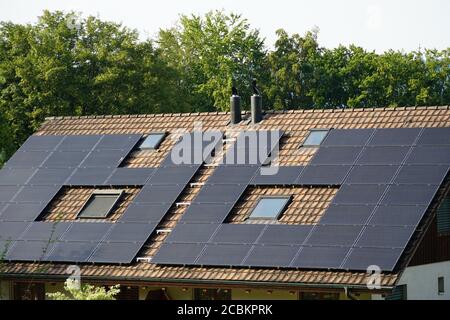 Flat plate or panels of solar collectors on the roof of the the family house for active heating. Stock Photo