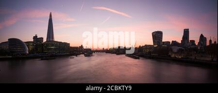 Silhouetted panoramic view of Thames river from Tower Bridge at dusk, London, UK Stock Photo