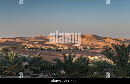 Distant view of Qsar Al Sarab desert resort among sand dunes, Empty Quarter Desert, Abu Dhabi, United Arab Emirate Stock Photo