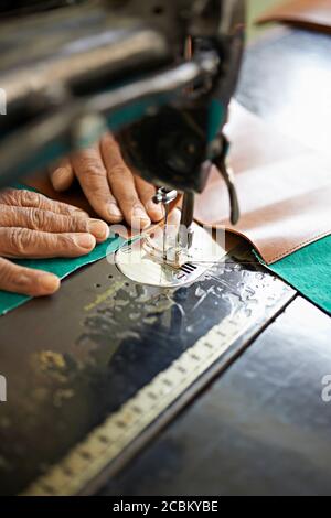 Female hands and sewing machine in textile factory, Thamel, Kathmandu, Nepal Stock Photo