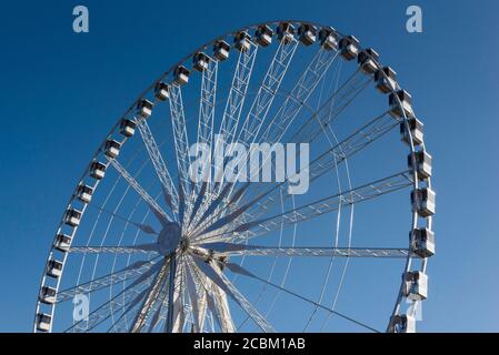 Top detail of ferris wheel against blue sky Stock Photo