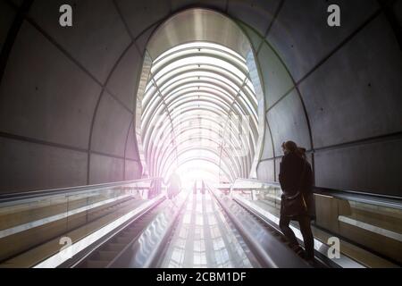 Rear view of woman ascending subway staircase in tunnel, Bilba, Spain Stock Photo