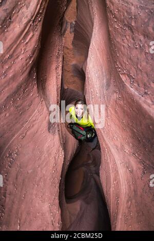 Woman exploring slot canyon Grand Staircase-Escalante National Monument, Utah, USA Stock Photo