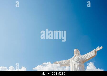 Statue of Christ against blue sky at Sacsayhuaman in Cusco, Peru Stock Photo