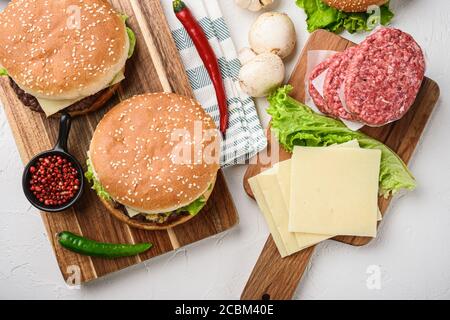 Set of beef burger and french fries and raw ingredients on white background, top view Stock Photo