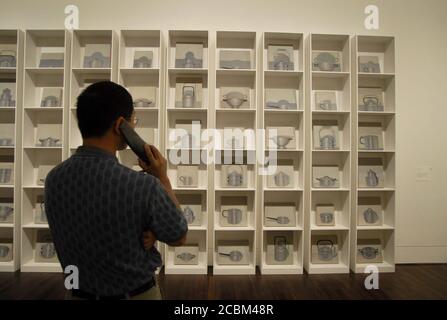 Austin, Texas USA, April 2006: Visitor uses a listening device to hear information about artwork during grand opening festivities at the Blanton Museum of Art on the campus of the University of Texas. ©Bob Daemmrich Stock Photo