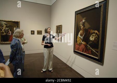 Austin, Texas USA, April 2006: Docent describes 'David with the Head of Goliath' by French artist Claude Vignon to visitors during grand opening festivities at the Blanton Museum of Art on the campus of the University of Texas. ©Bob Daemmrich Stock Photo