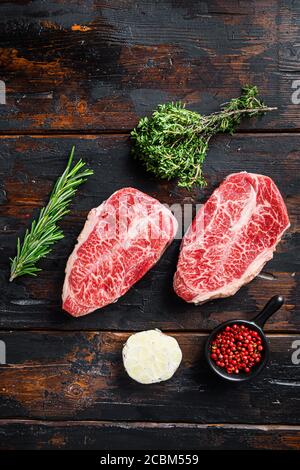 Top blade steak, bio raw meat, marbled beef . old wood table background. Top view Stock Photo