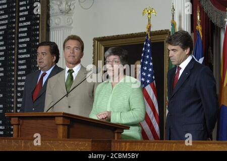 Austin, Texas USA, August, 25, 2006: Gov. Janet Napolitano of Arizona speaks to the press as governors Bill Richardson (left) of New Mexico,  Arnold Schwarzenegger of California and Rick Perry of Texas (far right) listen at the Border Governors Conference at the Texas Capitol. ©Bob Daemmrich Stock Photo