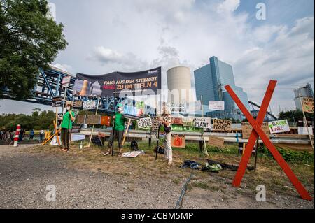 Datteln, Germany. 14th Aug, 2020. Climate activists are standing in front of the coal-fired power plant Datteln 4 on the Dortmund-Ems canal in front of the coal-fired power plant Datteln 4, which is operated by the Düsseldorf-based company Uniper, which is majority-owned by the Finnish energy supplier Fortum, as part of an action and protest day with a banner saying: 'Out of the Stone Age - No to Datteln 4'. Credit: Guido Kirchner/dpa/Alamy Live News Stock Photo