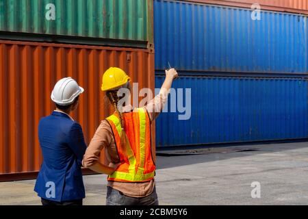 Women industrial workers and engineer are discussing the job planning in the logistic industry. Stock Photo