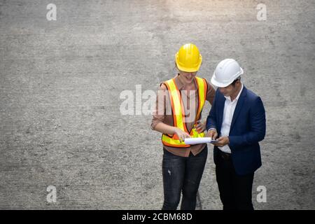 Women industrial workers and engineer are discussing the job planning in the logistic industry. Stock Photo