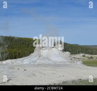 Late Spring in Yellowstone National Park: Castle Geyser Erupts in Upper Geyser Basin Stock Photo