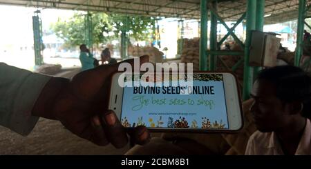 DISTRICT KATNI, INDIA - SEPTEMBER 20, 2019: Buying seeds online logo presented on smart phone screen by indian man holding mobile on hand for digital Stock Photo