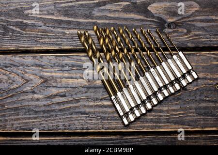 Drill Bit Set on Wooden Background Stock Photo