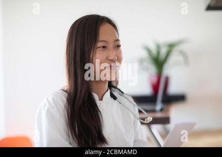 young asia female doctor with report in a practice Stock Photo