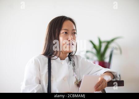 young asia female doctor with report in a practice Stock Photo