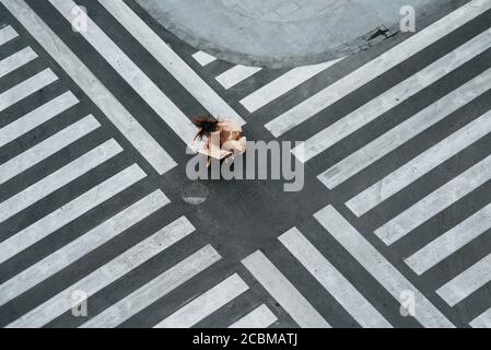 Woman dancing in a zebra crossing Stock Photo