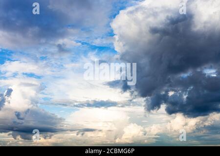 rain clouds block the sun in blue sky in summer Stock Photo