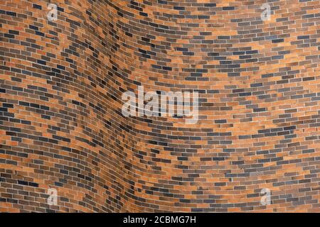 Curving brick wall provides interesting texture and pattern for abstract background. Stock Photo