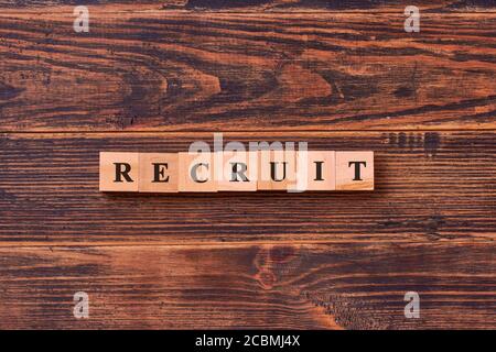 RECRUIT Word Written In Wooden Cube. Online recruitment and job search management business concept Stock Photo