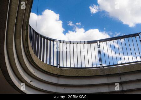 Modern Curved Bridge shot against a blue sky with clouds. Stock Photo