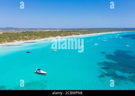 Boats on crystal clear water near Es Trenc beach, Mallorca, Spain Stock Photo