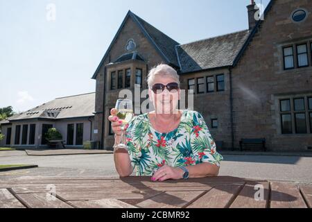 Caroline Hedley, 57, an auxiliary nurse at Hawick Community Hospital, enjoys the view at the Loch Fyne Hotel and Spa in Inveraray, Argyll and Bute, where she and other key workers received a 'sanctuary weekend'. Stock Photo