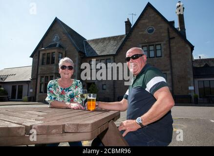Caroline Hedley, 57, an auxiliary nurse at Hawick Community Hospital, enjoys the view with her husband David at the Loch Fyne Hotel and Spa in Inveraray, Argyll and Bute, where she and other key workers received a 'sanctuary weekend'. Stock Photo