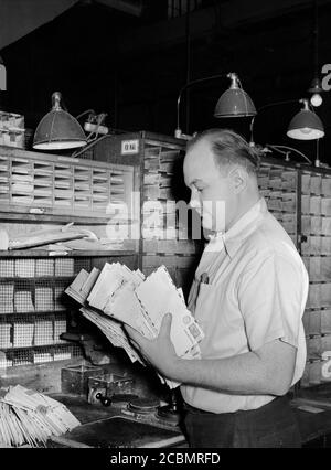 postal worker sorting mail at the main post office in malang java ...