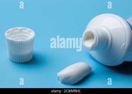 Morning hygiene and self-care concept. Toothpaste close-up on blue background Stock Photo