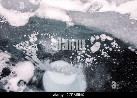 Methane bubbles under the frozen surface of Lake Baikal, Russia Stock Photo
