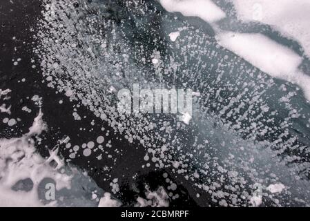 Methane bubbles under the frozen surface of Lake Baikal, Russia Stock Photo