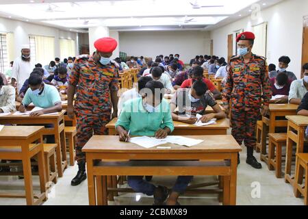 Applicants wearing face masks as a preventive measure while attend a recruitment test for fireman post under the Fire Service and Civil Defense department at a college amid Coronavirus (COVID-19) crisis in Dhaka. Stock Photo
