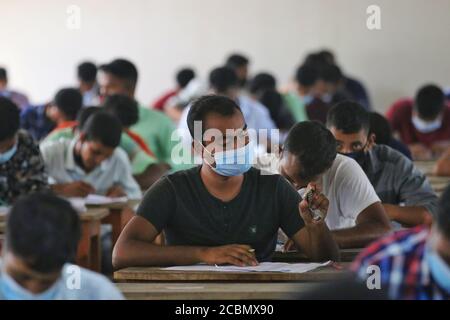 Applicants wearing face masks as a preventive measure while attend a recruitment test for fireman post under the Fire Service and Civil Defense department at a college amid Coronavirus (COVID-19) crisis in Dhaka. Stock Photo