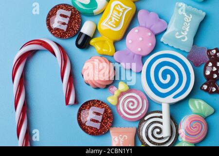 New Year concept design with cheerful toys and sweets. Christmas objects on blue background Stock Photo