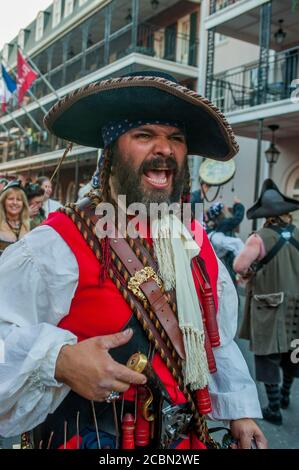 A pirate parade in the evening through Bourbon Street in the historic French Quarter of New Orleans, Louisiana, USA. Stock Photo