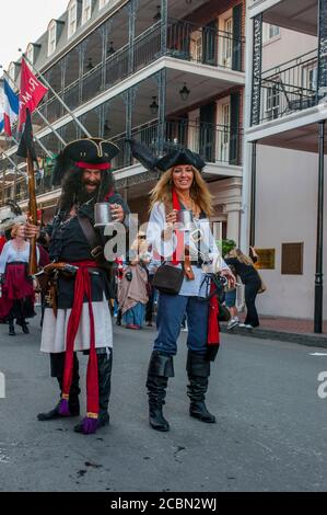 A pirate parade in the evening through Bourbon Street in the historic French Quarter of New Orleans, Louisiana, USA. Stock Photo