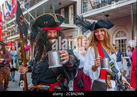 A pirate parade in the evening through Bourbon Street in the historic French Quarter of New Orleans, Louisiana, USA. Stock Photo