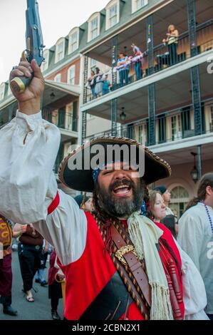 A pirate parade in the evening through Bourbon Street in the historic French Quarter of New Orleans, Louisiana, USA. Stock Photo