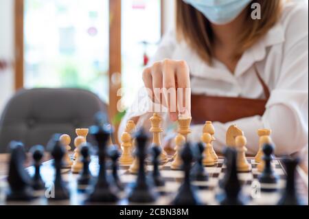 Woman playing chess in club, leisure activity of weekend and compitetion concept Stock Photo