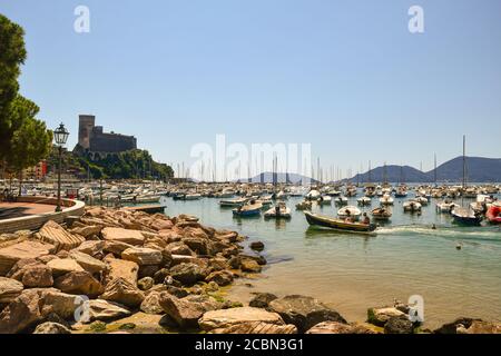 Scenic view of the harbor from the rocky shore with the medieval castle of the old fishing village in summer, Lerici, La Spezia, Liguria, Italy Stock Photo