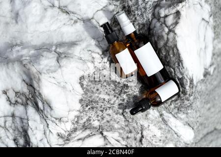 Cosmetic bottles on a marble background. Top view with space for text. Stock Photo