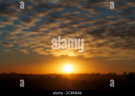 Blurred landscape background with sunset, cirrus clouds in the city. Stock Photo