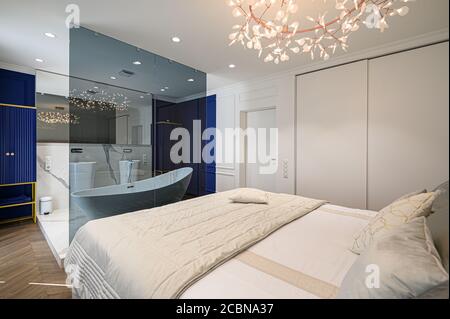 Big comfortable double bed in elegant classic bedroom Stock Photo