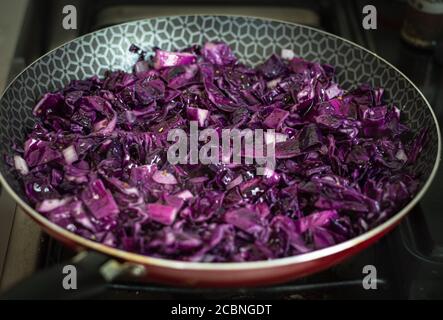 Purple cabbage in a frying pan being cooked Stock Photo