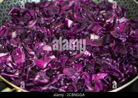 Purple cabbage in a frying pan being cooked Stock Photo